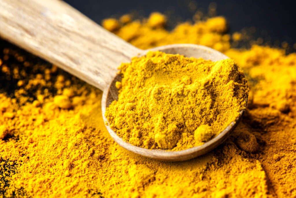 closeup-tumeric-powder-spice-spoon-scaled